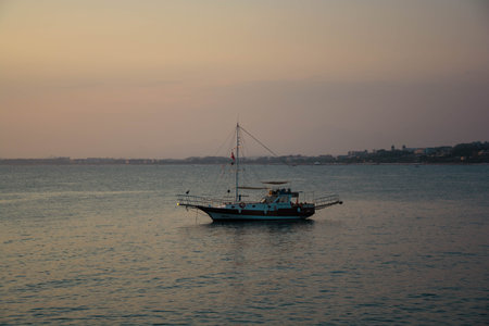 Fishing boat in the sea at sunset. Small fishing boat in the sea.