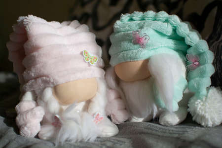 Two gnomes with a soft pink dress and a turquoise hatの写真素材
