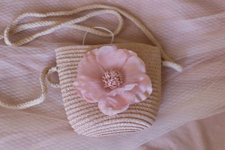 Stylish textile bag with a pink flower on a beige backgroundの写真素材