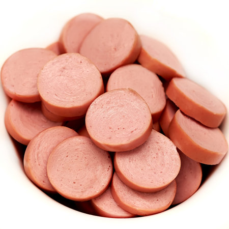 sausage slices in a bowl on white background