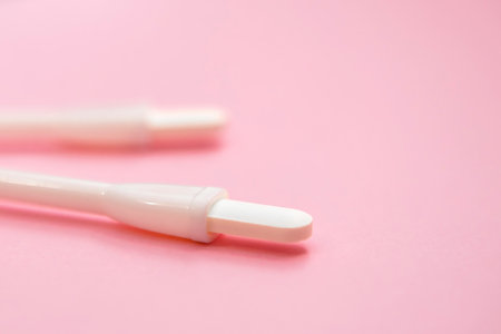 Two vaginal suppositories on a pink background. Caring for women's health. Close-upの写真素材