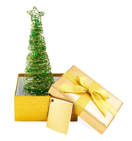Christmas tree in golden box with bow isolated on white backgroundの写真素材