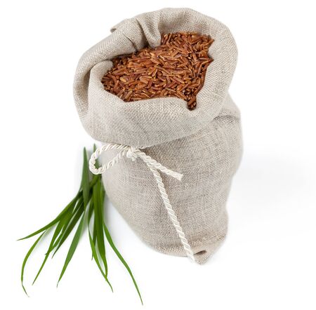 Macro view of sack of red rice with greens isolated on white backgroundの写真素材