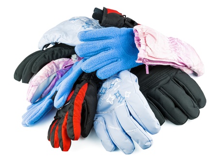 Multicolored mixed ski gloves varied in size isolated on white backgroundの写真素材