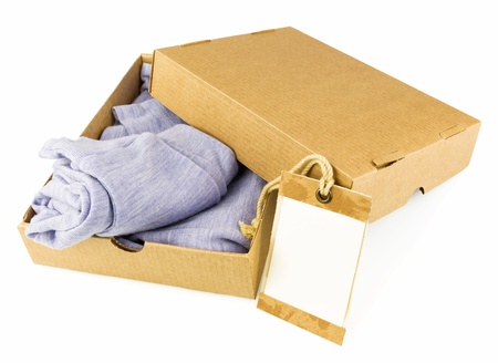 Clothes in open carton isolated on white backgroundの写真素材