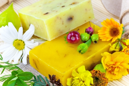 Macro view of natural soap and flowers on the matの写真素材