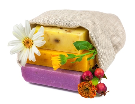 Macro view of handmade soap in sack with flowers and berries isolated on white backgroundの写真素材