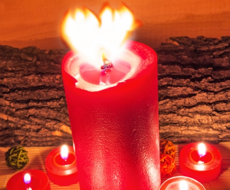 Heart shape of flame with lighted candlesの写真素材