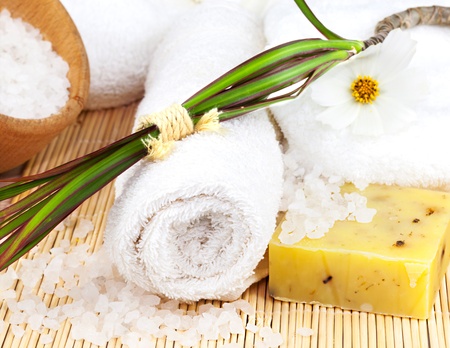 Bath towel with sea salt, with flower and plant on the matの写真素材