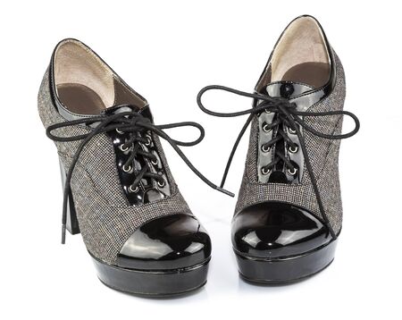 Black patent-leather lady lace-ups boots isolated on white backgroundの写真素材