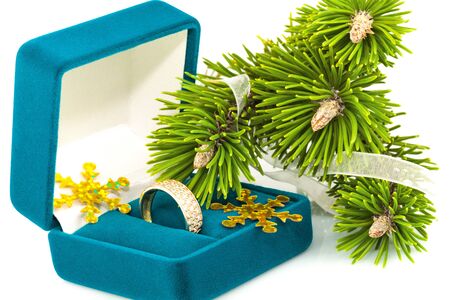 Box with golden ring and twig Christmas tree isolated on white backgroundの写真素材