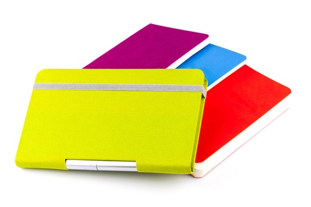 Colourful notebooks with ballpoint pen isolated on white backgroundの写真素材