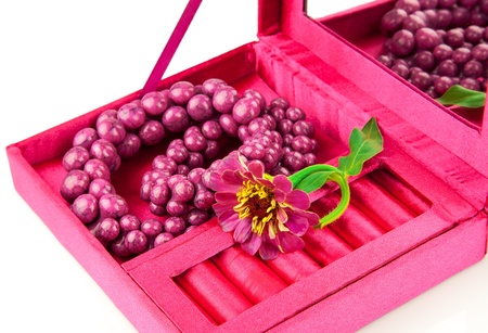 Open pink box with decoration and flower isolated on white backgroundの写真素材