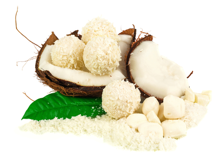 Coconut with coconut candy and green leaf isolated on whiteの写真素材