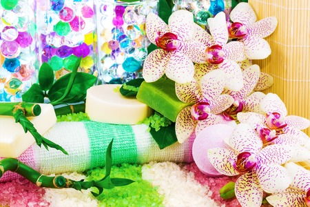 Spa concept with sea salt, soap, bamboo, orchid, towel, ballsの写真素材