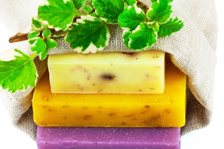 Macro view of handmade soap in sack with branch with leavesの写真素材