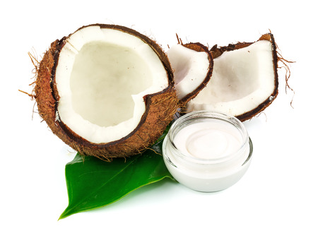Coconut cocos with cream and green leaf isolated on white backgroundの写真素材