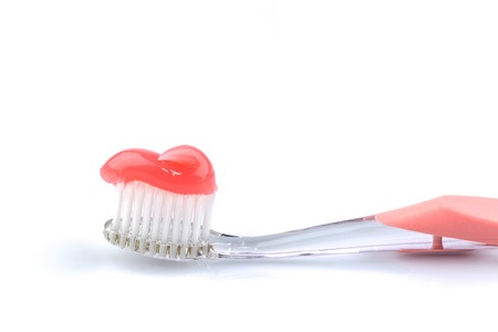 Toothbrush with pink toothpaste isolated on white backgroundの写真素材