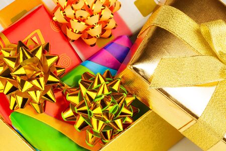 Open gold box with gifts insideの写真素材