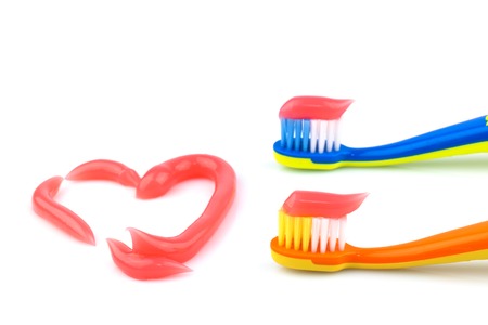 Toothbrushes with pink toothpaste isolated on white backgroundの写真素材