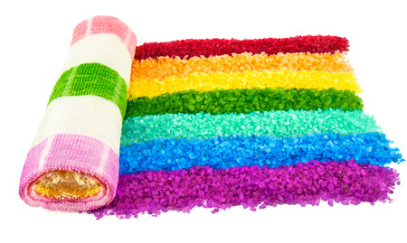 Macro view of bright rainbow of sea salt and towel isolated on white backgroundの写真素材