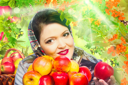 Woman with organic apple with roman berry and green leavesの写真素材