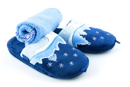 Blue soft terry slippers with towel isolated on white backgroundの写真素材