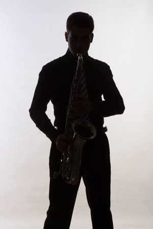 Saxophonist silhouette on grey backgroundの写真素材
