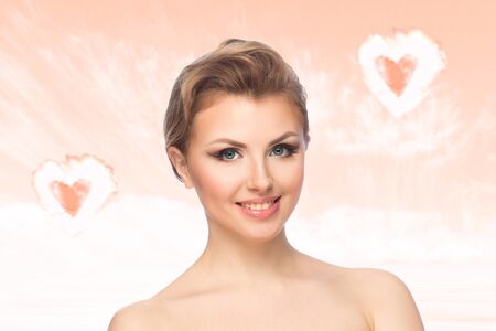 Women in love on pink background with shapes of heartsの写真素材