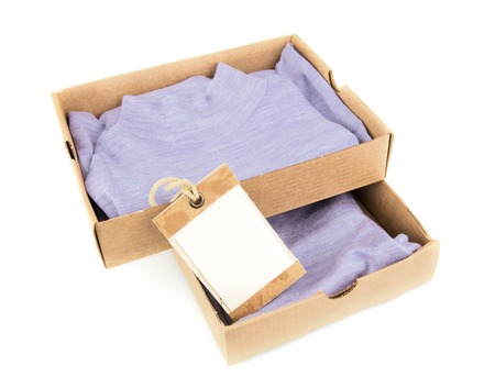 Clothes in open containers with card isolated on white backgroundの写真素材