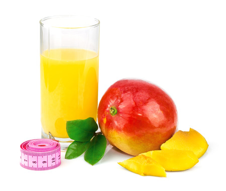 Mango juice in glass, mango fruit with centimeter and leaves isolated on white backgroundの写真素材