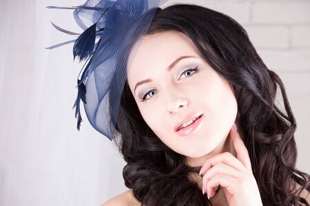 Dreamy girl with blue eyes in blue hatの写真素材
