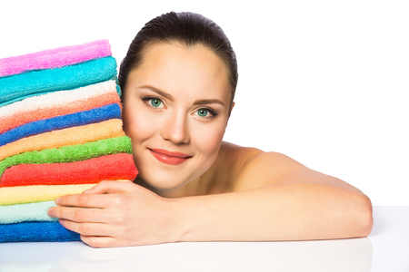 Portrait of beautiful spa girl with colorful towels isolated on white backgroundの写真素材