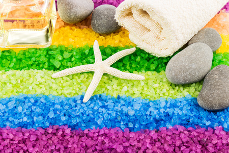 Color sea salt rainbow with shell, stones, aroma oil and bath towelの写真素材