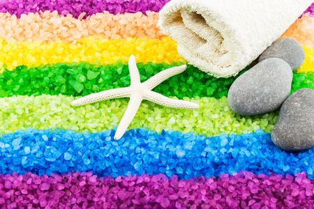 Color sea salt rainbow with sea star, stones and bath towelの写真素材