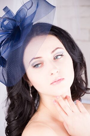 Dreamy girl with blue eyes in blue hatの写真素材