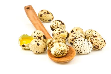 Quail eggs in a wooden spoon isolated on white backgroundの写真素材