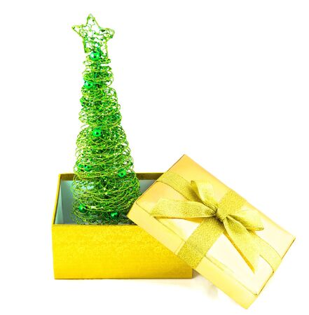 Christmas tree in golden box isolated on white backgroundの写真素材