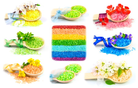 Macro view of wooden spoons with color bath salt and flowers, set isolated on white backgroundの写真素材