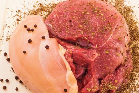 Macro view of fresh raw meat with black pepper and dry spicesの写真素材