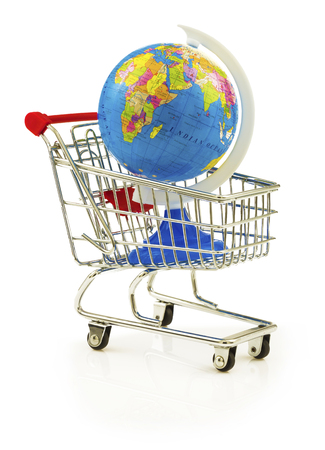 Globe in the shopping cart isolated on white backgroundの写真素材