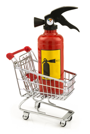 Extinguisher standing in the shopping cart isolated on white backgroundの写真素材