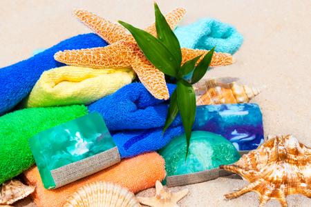 Multicolor spa beauty concept with towels, soap, shells and green fresh plant bambooの写真素材