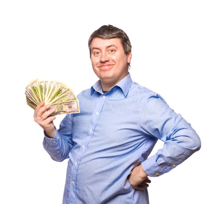 Smiling man in a blue shirt with money dollars isolated on white backgroundの写真素材