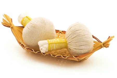 Thai massage product: pouches, a basket isolated on white backgroundの写真素材