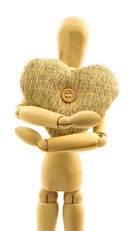 Macro view of wooden male person with knitted woolen heart with button isolated on white backgroundの写真素材