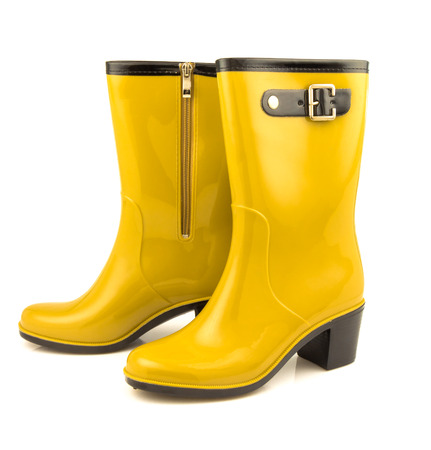 Yellow rubber boots isolated on white backgroundの写真素材
