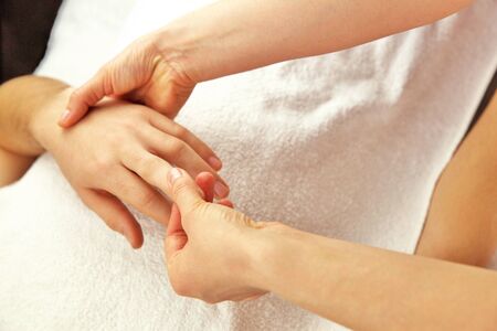 Hand massage with white towelの写真素材