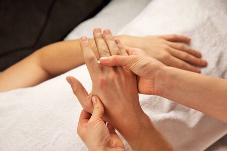 Hand massage with white towel, spa salonの写真素材