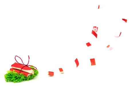 Red crab sticks of surimi on fresh green lettuce with tie and slices isolated on white backgroundの写真素材